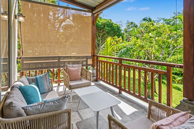 Cushioned lounge corner on the veranda overlooking the greenery